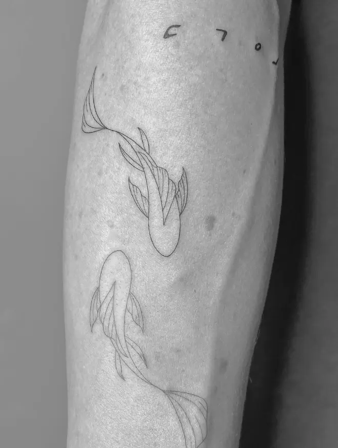Koi fish tattoo with delicate line work by Chelsea.Q